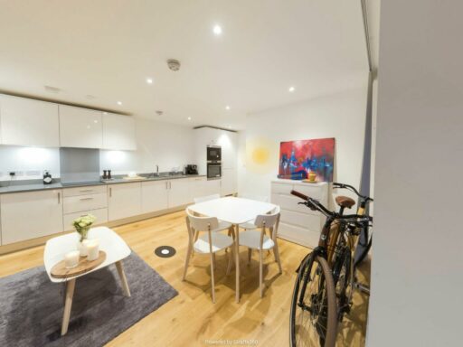 A kitchen with wooden floor and small table