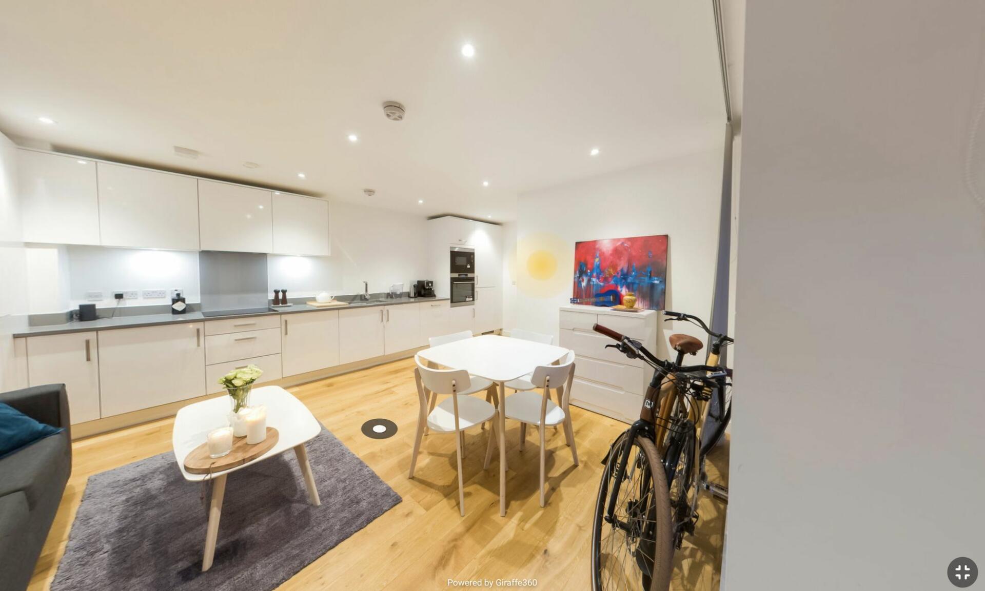 A kitchen with wooden floor and small table