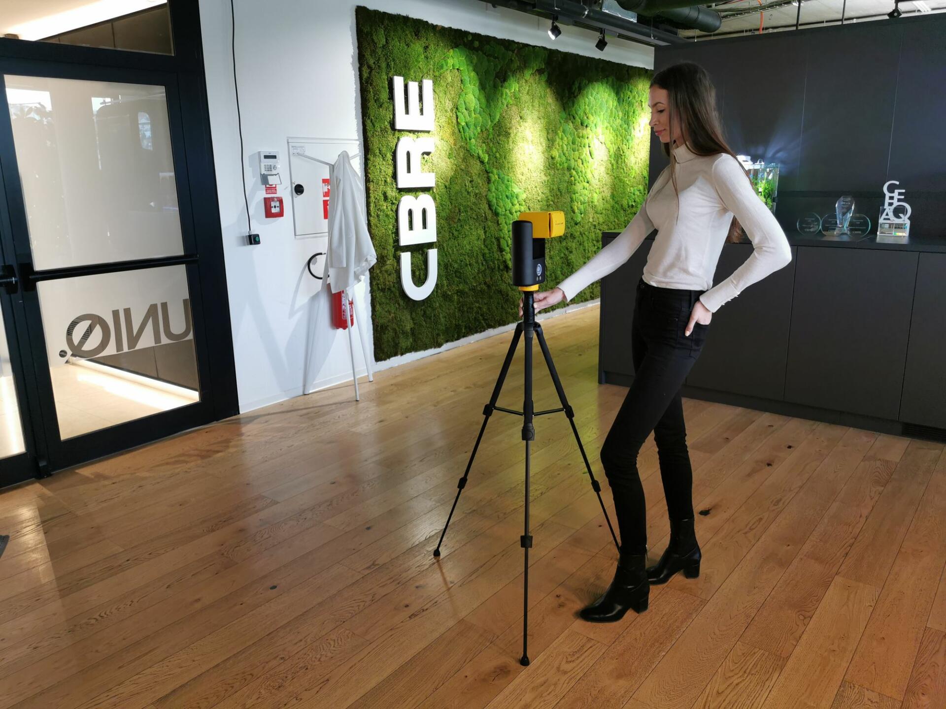 female stood with giraffe 360 camera in a showroom